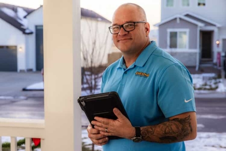 Technician smiling with checklist in hand