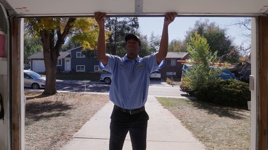 technician inspecting garage door