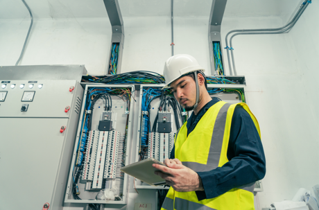 Man in front of electrical panel