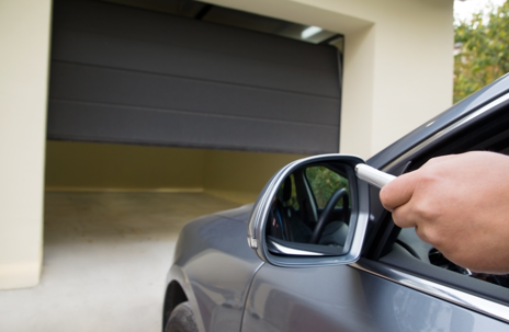 Car pulling into garage with door half open