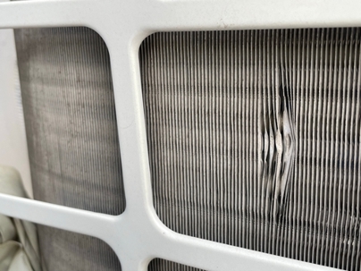 Close up of damaged AC condenser coil fins.