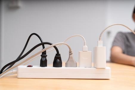 Close up of power strip with cords plugged in.