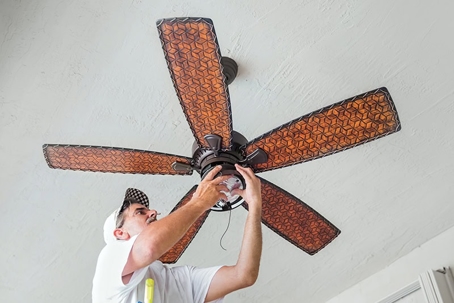 technician installing a ceiling fan